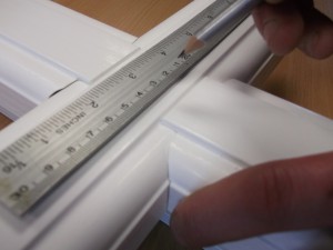 Craftsman hand finishing a Residence 9 window
